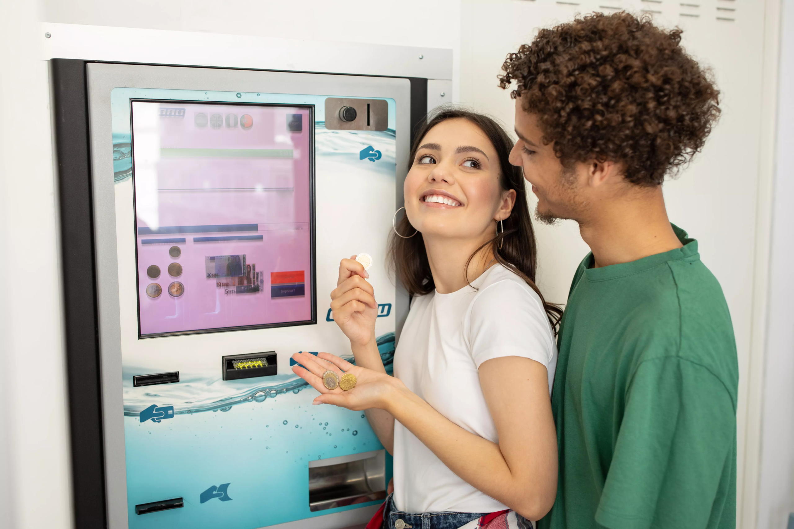young-couple-enjoying-snacks-from-a-vending-machin-2024-10-24-18-05-59-utc (1)